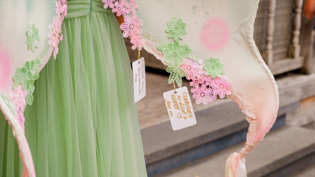 Wing of an elf with handwritten cards from the guests hanging from it